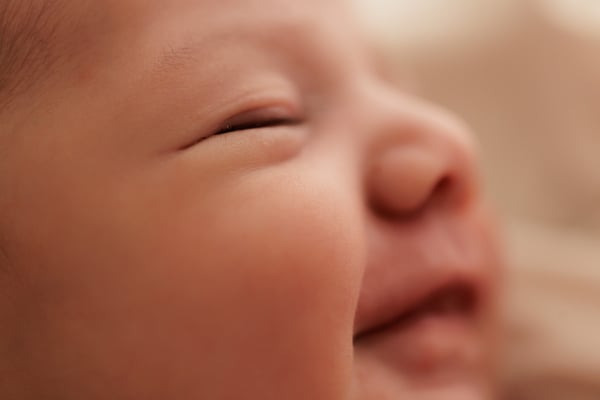 Close view of a sleeping newborn's cheek and closed eye