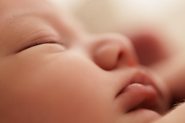 Extreme close-up of a sleeping newborn's nose and lips